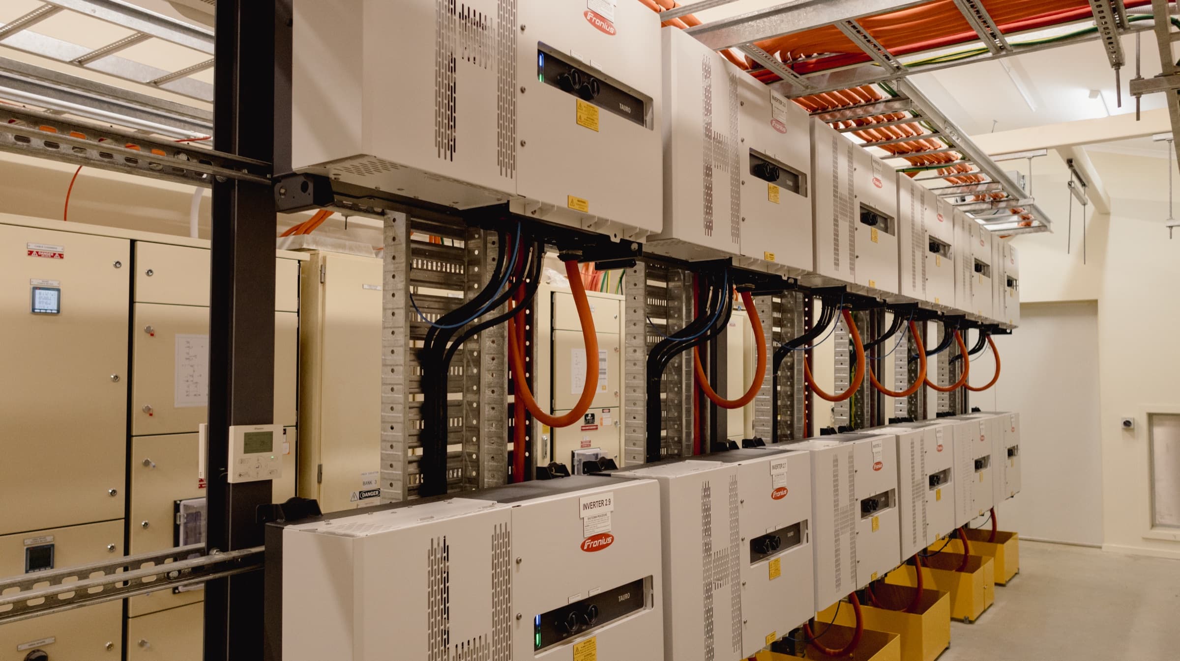 Bank of string inverters with DC and AC cabling in the plant room